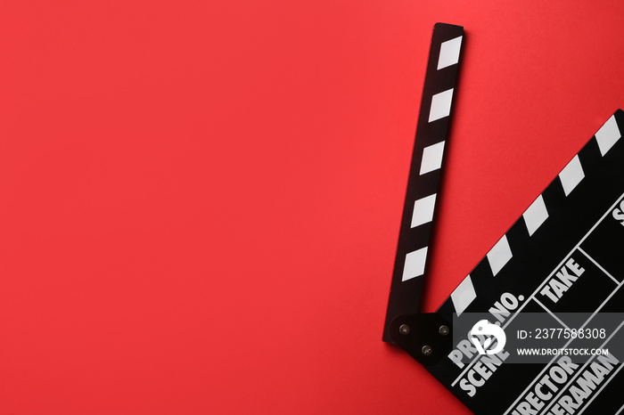 Cinema clapperboard on color background