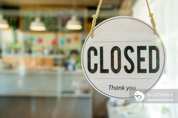 Closed. coffee cafe text on vintage sign board hanging on glass door in modern cafe coffee shop, reo