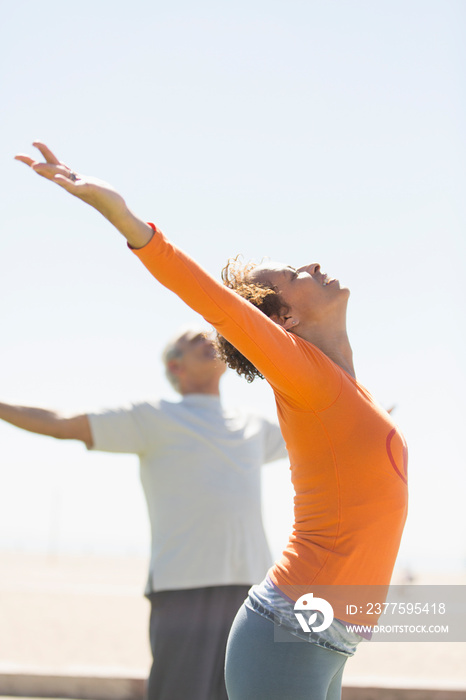 Active seniors practicing yoga outdoors