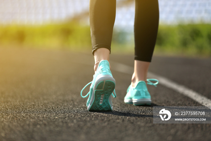 Sporty young woman running at the stadium