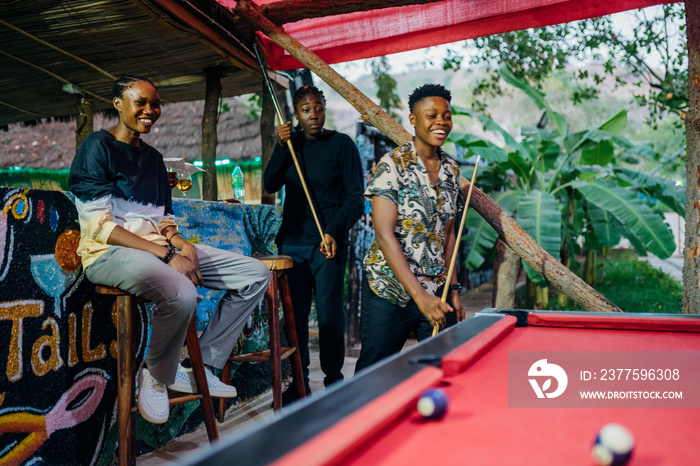 Queer masculine women playing pool