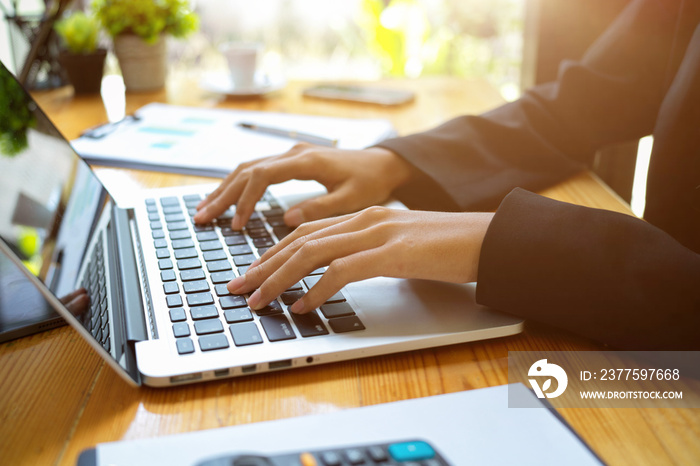 Female or business woman working on digital laptop computer