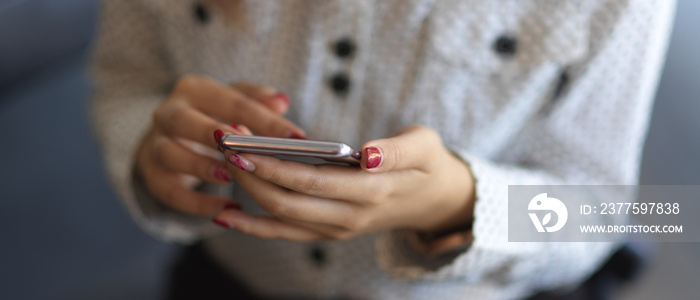 Close up view of female hands texting on smartphone