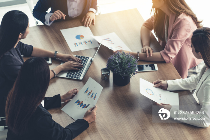 Businesswoman in group meeting discussion with other businesswomen colleagues in modern workplace of