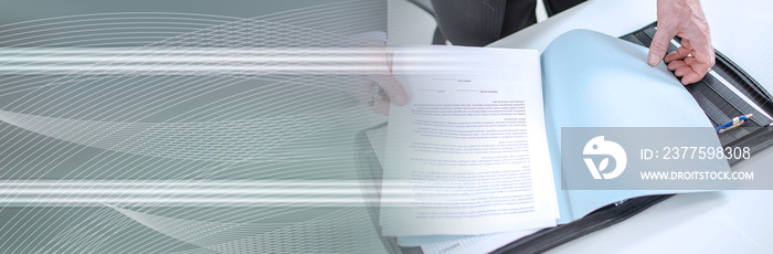 Businessman looking at a document; panoramic banner