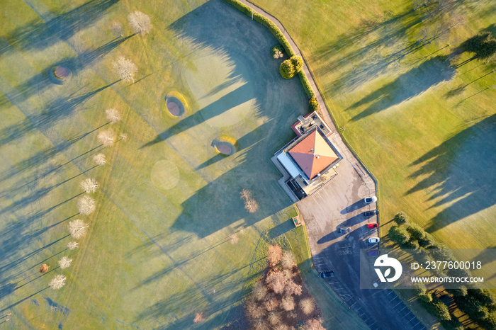 Aerial view of golf course green and clubhouse from above frozen grass in winter at Aboyne Aberdeenshire Scotland