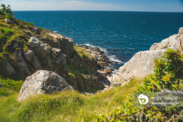 steep cliffs and green landscape of nothern Bornholm coastline at baltic sea, Denmark