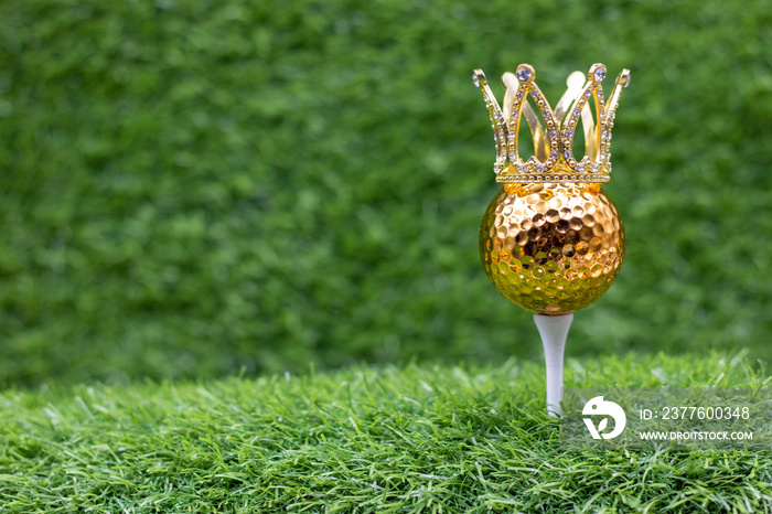 Golden golf ball is on green grass background