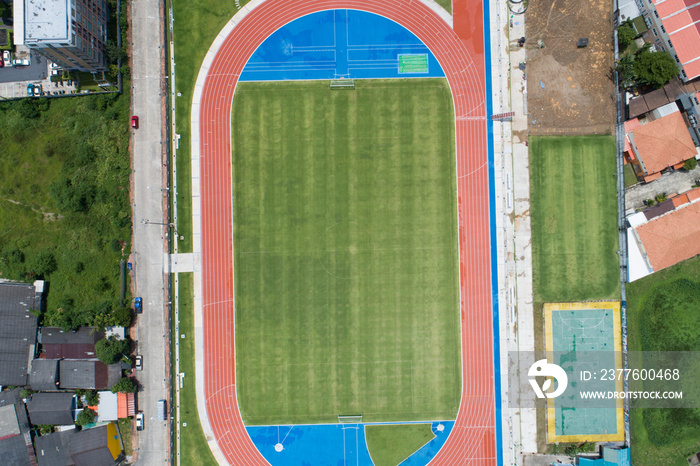 Aerial view of empty new soccer field from above with running tracks around it Amazing new small stadium for many sport disciplines at phuket thailand