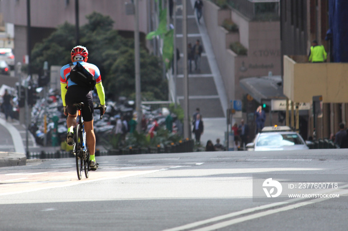 Athletic cyclist riding down hill on Druitt Street, Sydney