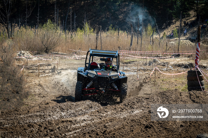 ATV and UTV offroad vehicle racing in hard track with mud splash. Amateur competitions. 4x4.