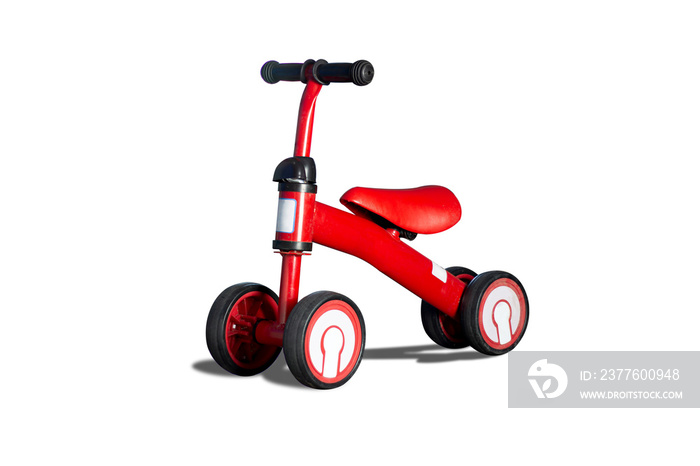 Small red tricycle or scooter for young children or toddler using their foot to walk with clipping path.