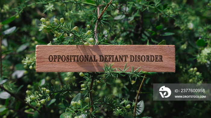 Oppositional Defiant Disorder . Written on wooden surface. Background tree leaves. health and sport.