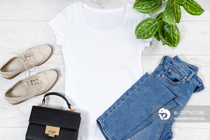 White female t shirt outfit mock up flat lay on wooden background. Top view and copy space. Mockup t-shirt and summertime. Template blank shirt. Outfit set