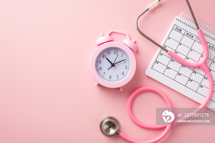 Breast cancer awareness concept. Top view photo of pink stethoscope alarm clock and calendar on isolated pastel pink background