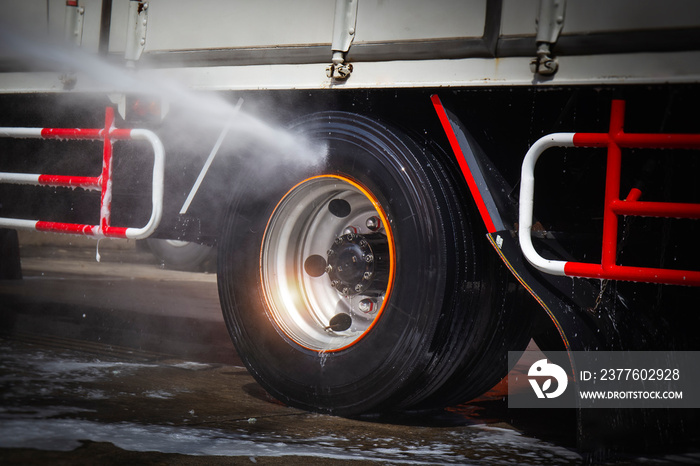 High Pressured Water Washing Truck Wheels. Cleaning Truck Tires