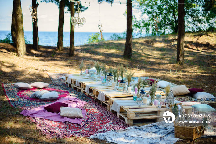 Boho style party decor in the forest. Party decoration for a bachelorette party.