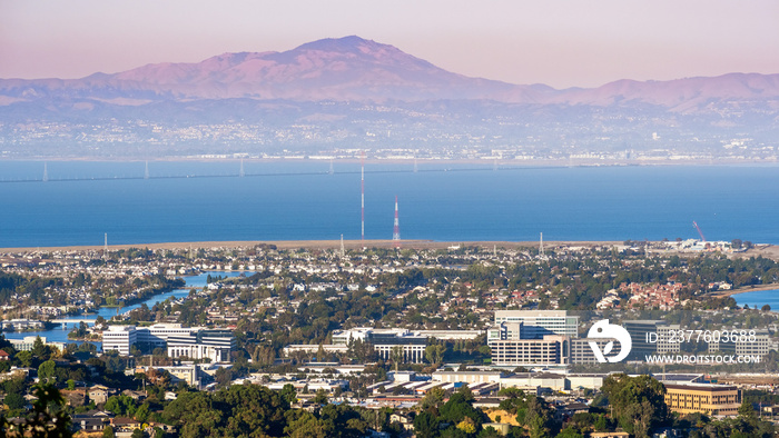 Aerial view of San Carlos and Redwood Shores; East Bay and Mount Diablo in the background; pollution and smoke visible in the air