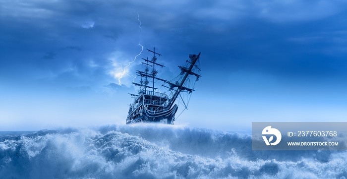 Sailing old ship in a storm sea in the background stormy clouds with lightning