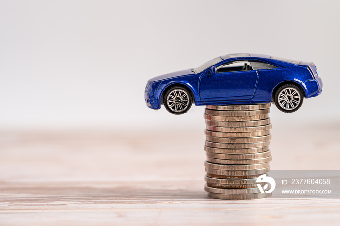 Car on stack of coins. Car loan, Finance, saving money, insurance and leasing time concepts.