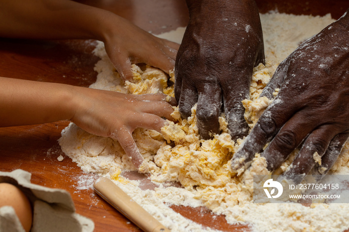 Hands mix dough for baking