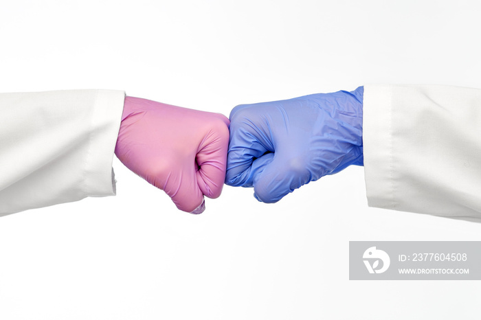 hands of doctors in gloves make fist bump gesture