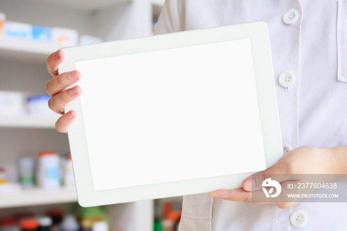 pharmacist showing tablet computer over pharmacy background