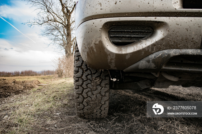 Closeup photo of car wheel on muddy terrain