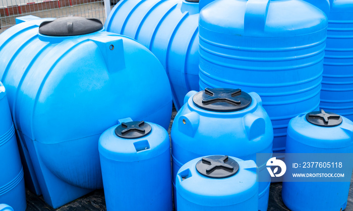 blue plastic barrels for drinking water, liquid storage tanks