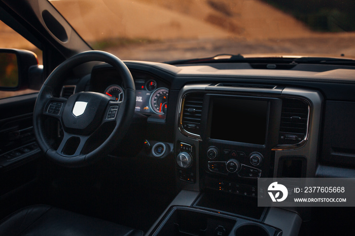 Modern suv car interior with leather panel, multimedia and dashboard