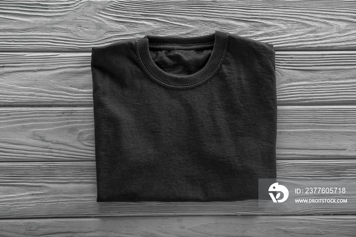 Blank black t-shirt on wooden background