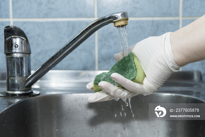 Washung sponge in the sink