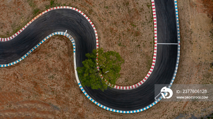 Aerial top view motorsport race asphalt track circuit motor racing track, Race track curve, Curving race track view from above, Aerial view car race asphalt track and curve.