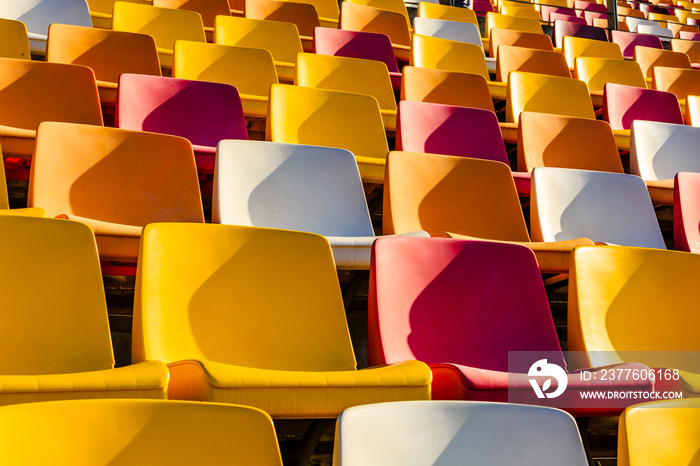 Empty plastic chairs in the stadium.