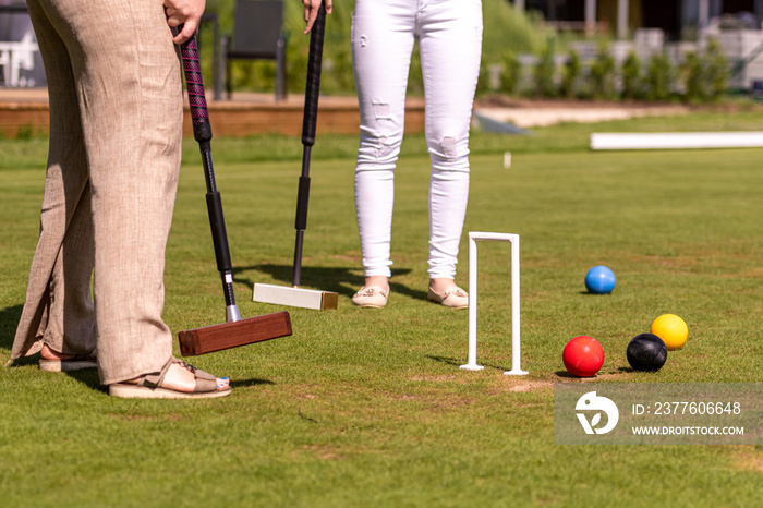 females croquet player hitting the ball with mallet