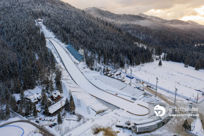 Large ski jump in Zakopane called Huge Krokiew names Stanislawa Marusarza, winter aerial view.