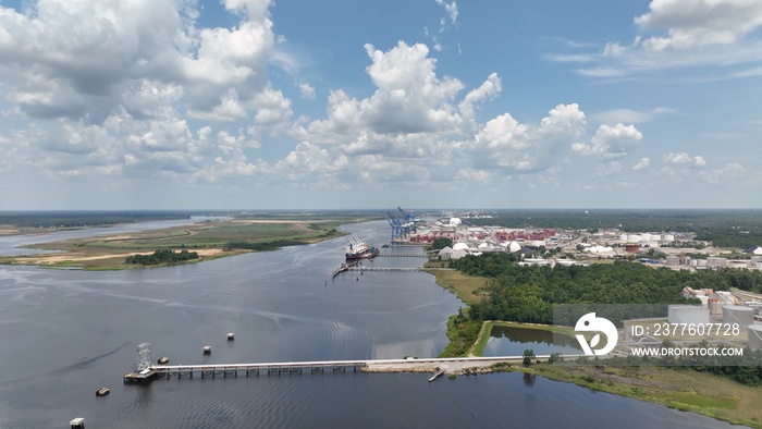 Wilmington, NC shipping port with cargo containers docked  and unloading