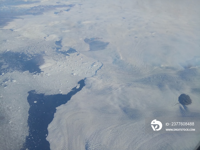 Vanishing coastlines of Greenland as seen from an airplane