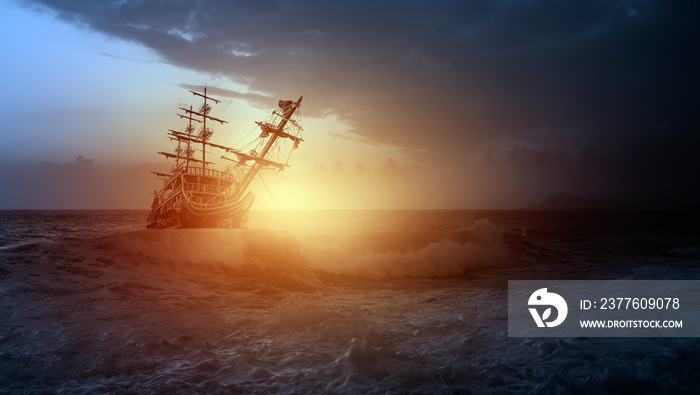 Sailing old ship in a storm sea in the background stormy clouds