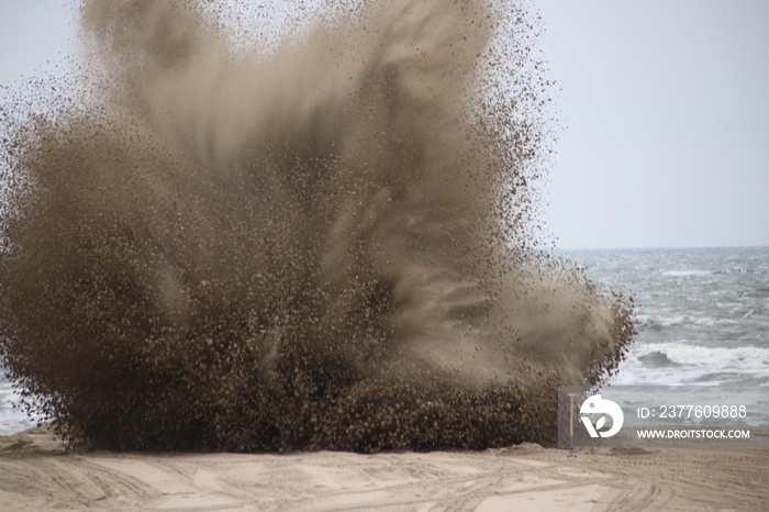 Explosive specialist of the Police (TEV) and the army (EOD) bringing criminal explosives to an explosion on the beach of scheveningen close to The Hague,the Netherlands