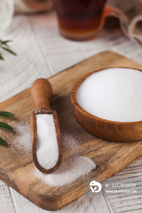 Natural sweetener in a wooden spoon. Sugar substitute. Erythritol