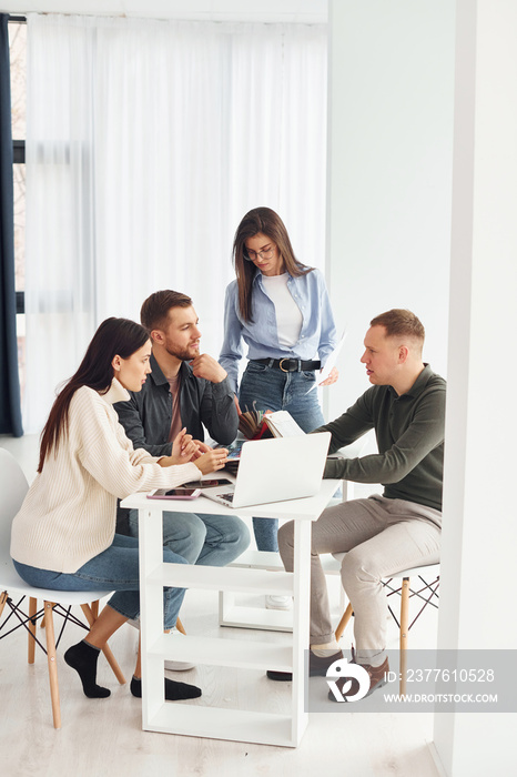 Group of people works in the office by sitting by the table