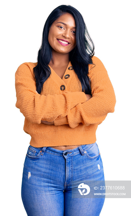 Hispanic woman with long hair wearing casual winter sweater happy face smiling with crossed arms looking at the camera. positive person.