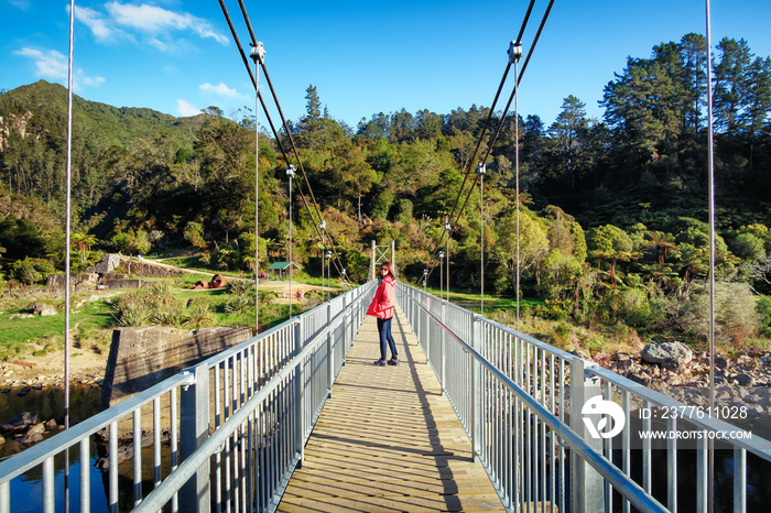 Young female traveler tourist visiting Karangahake nature scenery in North Island, New Zealand