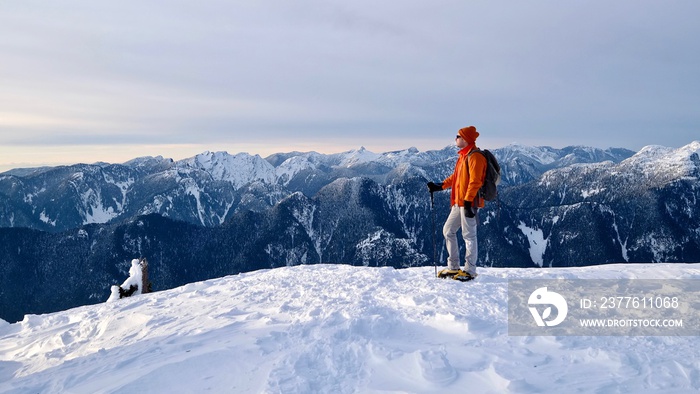 Man snowshoeing on mountain top. Seymour Mountain Provincial Park. North Vancouver. British Columbia. Canada.