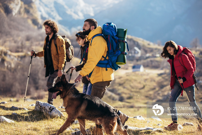 Group of hikers walking on a mountain at autumn day