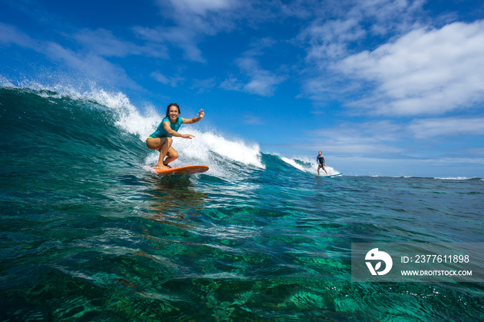 beautiful girl surfing on big transparent waves