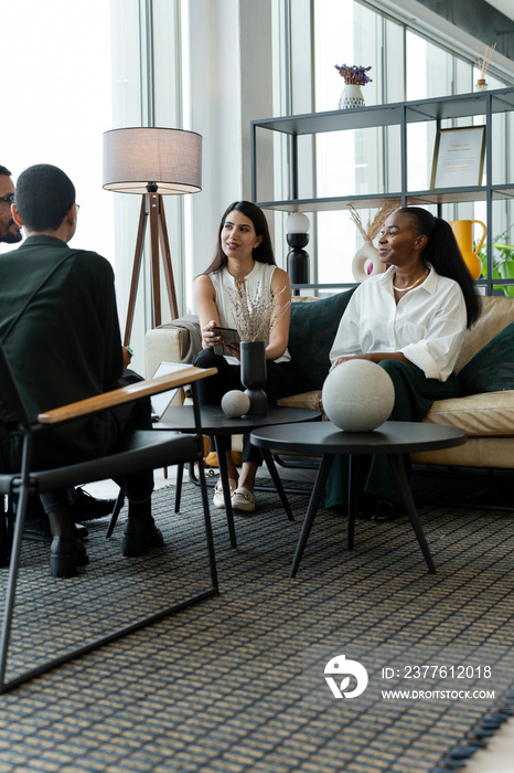 Business people having meeting in office lobby