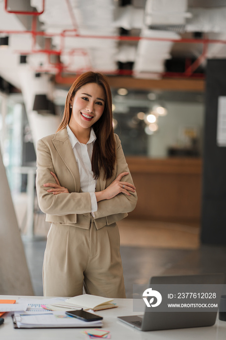 Asian businesswoman working on laptop computer in office with documents on desk woman looking at financial statistics data analysis chart profit growth business idea vertical image