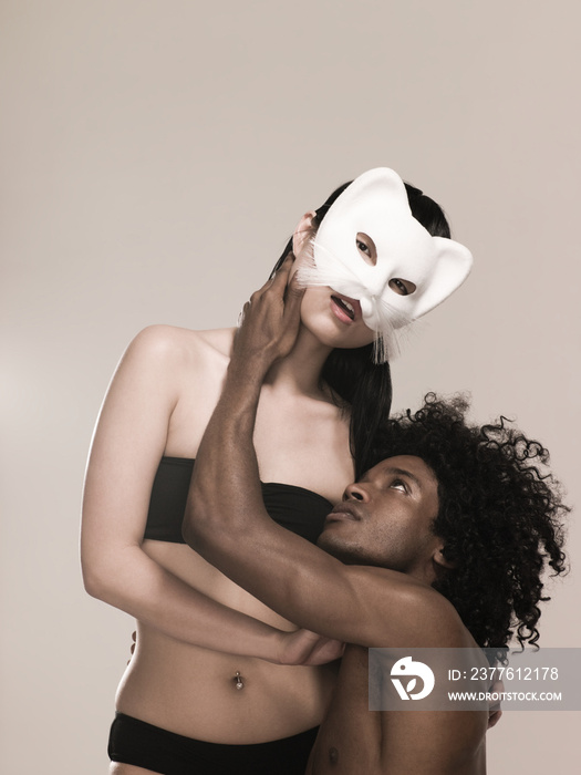 Man touching woman in a cat mask